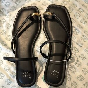 A new day black with gold metal toe ring sandals